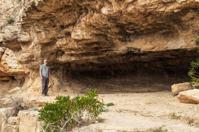 Many standing next to an overhang