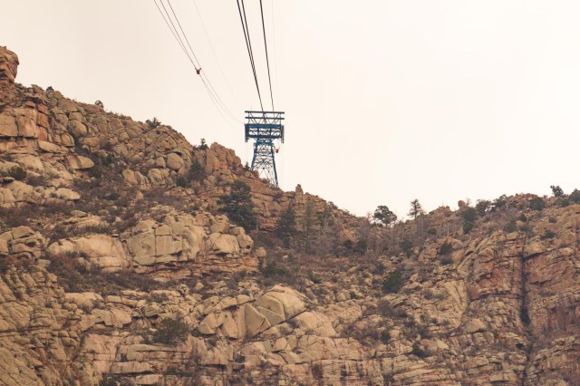 Tram cable tower atop a rocky cliff