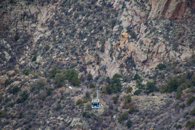 Mountainous canyon with tram suspended from cable