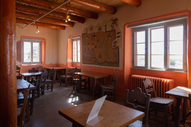 Inside adobe building with chairs and tables