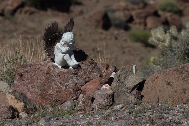 Angel statue sitting on a rock