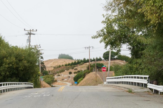 Bridge leading to a cemetery on a hill