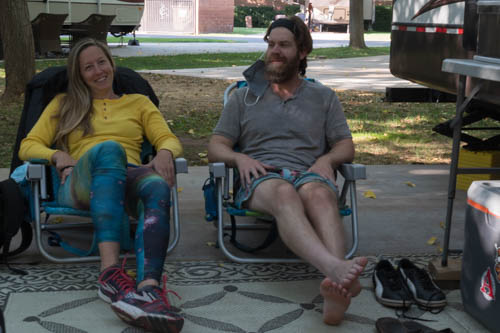 Man and woman relaxing on beach chairs.