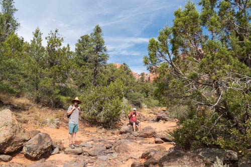 Two kikers taking a break in a rocky riverbed