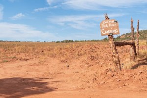 Red sandy field with camping sign