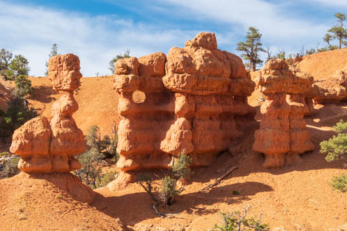 Red rock formations, blue sky, and wispy clouds