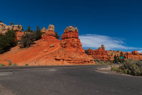 Red rock formations next to a road