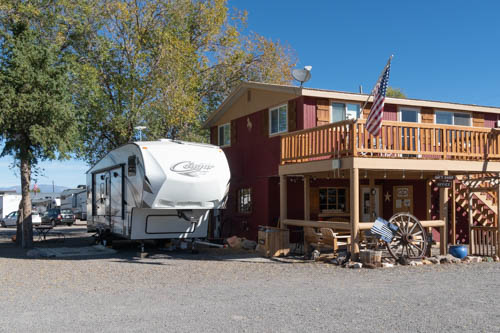 Wood 2-story building and fifth wheel trailer