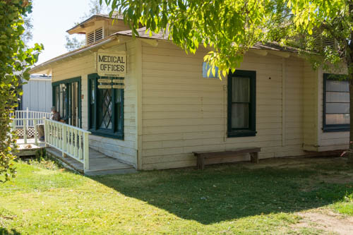 Yellow building with black framed windows and sign that says medical offices