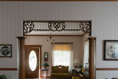 Inside an early 1900s home with wood accents and papered walls