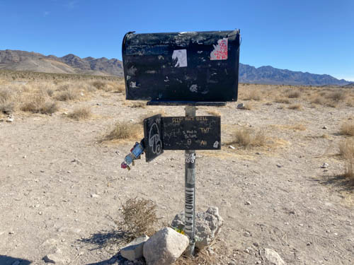 Black mailbox in the desert