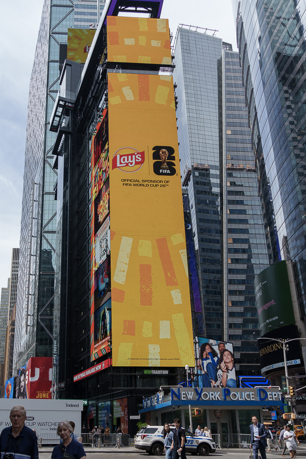 Large digital billboard in Times Square featuring a Lay's advertisement promoting their sponsorship of the FIFA World Cup 2026.
